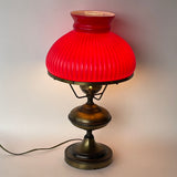 Vintage Early American Aged Brass Oil Lamp Style Table Lamp with Ruby Red Ribbed Student Shade